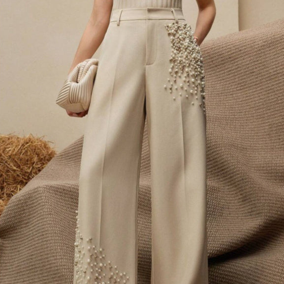 Pantaloni eleganti a pieghe da donna con una tasca alla moda impreziosita da perle